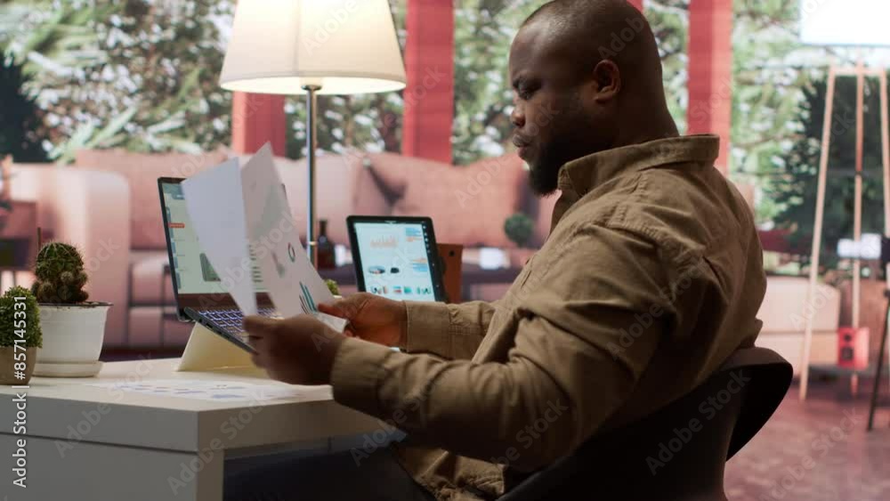 Business owner reviewing key performance indicators within the enterprise activity, remote work at home. Conducting evaluations to help with global expansion, finance and economy. Camera A.