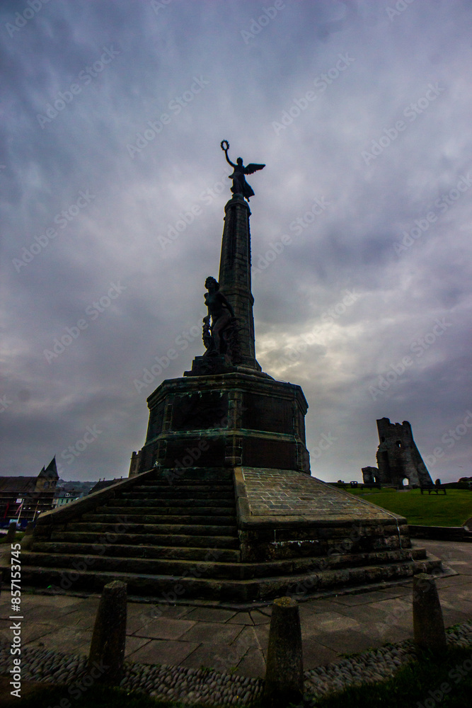 The World war memorial at Aberystwyth at dawn, with the ruins of the medieval Castle in the Background The World war memorial at Aberystwyth at dawn, with the ruins of the medieval Castle in the Background