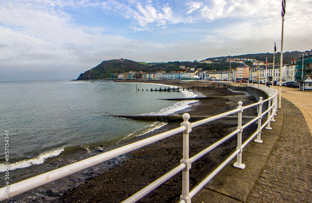 View along the walkway of the promenade of Aberystwyth in Wales with constitution hill in the background