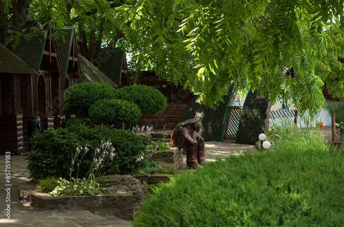 a beautiful corner of the garden with molded landscaping, sculpture and gazeb...