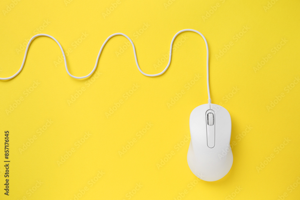 One wired mouse on yellow background, top view. Space for text One wired mouse on yellow background, top view. Space for text