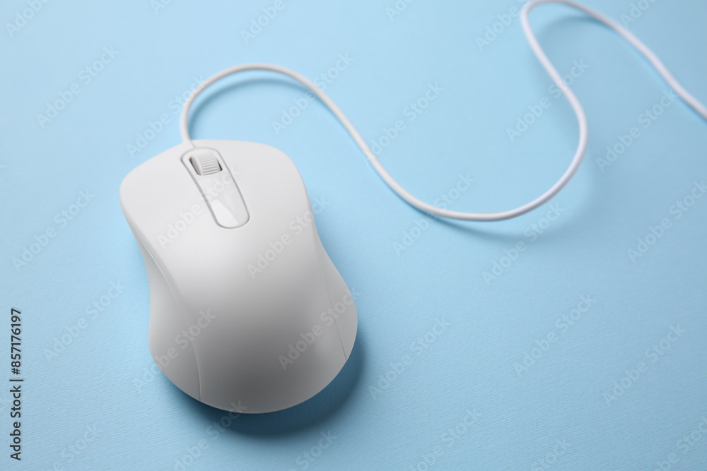One wired mouse on light blue background, closeup One wired mouse on light blue background, closeup