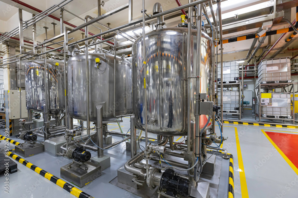 Stainless vertical steel tanks and pipes with pressure meter in equipment tank chemical cellar at the with stainless steel Stainless vertical steel tanks and pipes with pressure meter in equipment tank chemical cellar at the with stainless steel