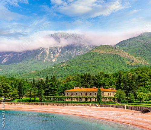 awesome landscape of sea gulf with beautiful turquoise water with amazing green forest shore wwith pakr and hotel and nice green mountains on background photo