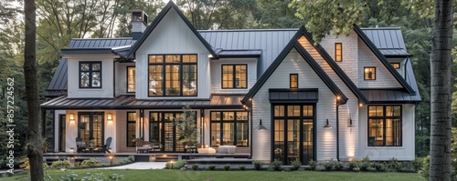 Modern farmhouse with black trim and a metal roof. © peppastock