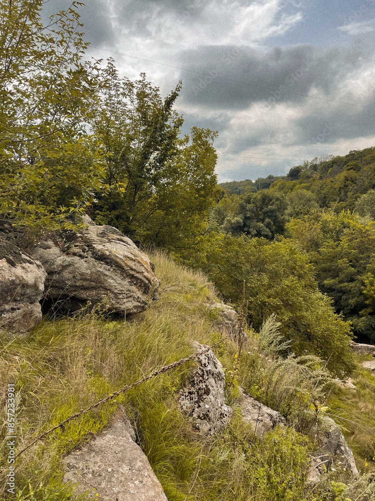 Traveling along the mountain cliffs of a large canyon by boat in the middle of the lake. The beauty and tranquility of wild forests and green plants far from the city. Peace and relaxation Traveling along the mountain cliffs of a large canyon by boat in the middle of the lake. The beauty and tranquility of wild forests and green plants far from the city. Peace and relaxation