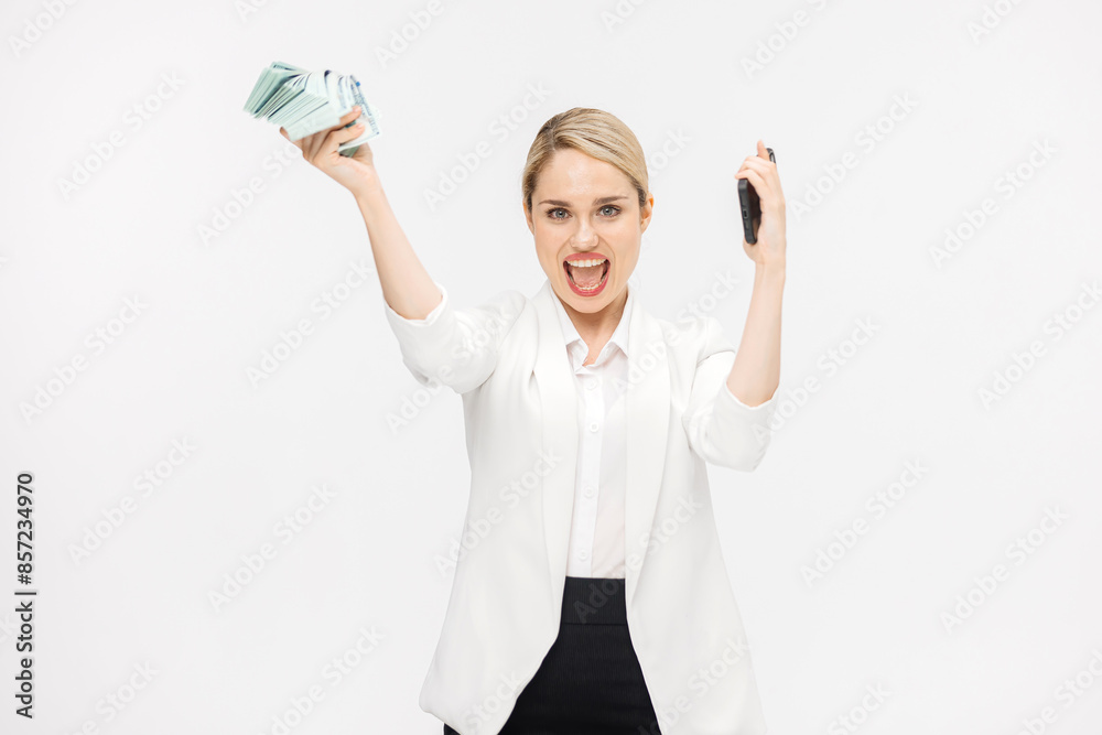 Obraz premium Successful business woman rejoices and enjoys a large sum of money on a white studio background. Concept of successful business, credit and financial services.