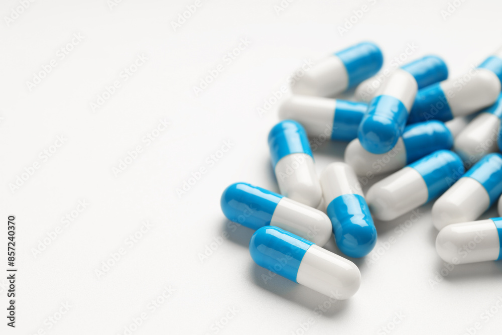 Antibiotic pills on white background, closeup. Space for text Antibiotic pills on white background, closeup. Space for text