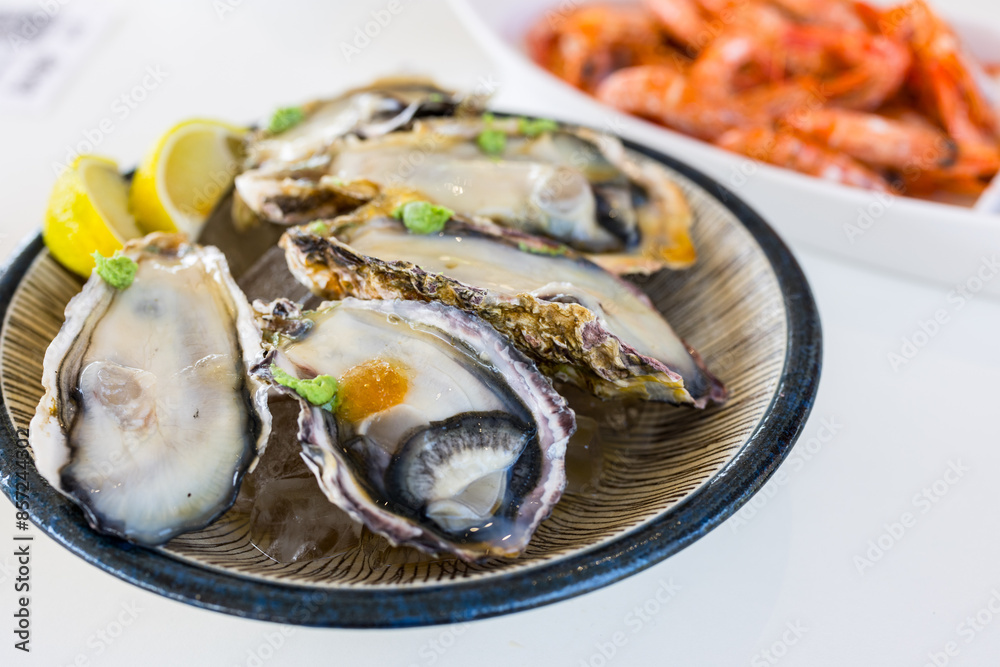 Tasty fresh raw oyster on the plate in restaurant