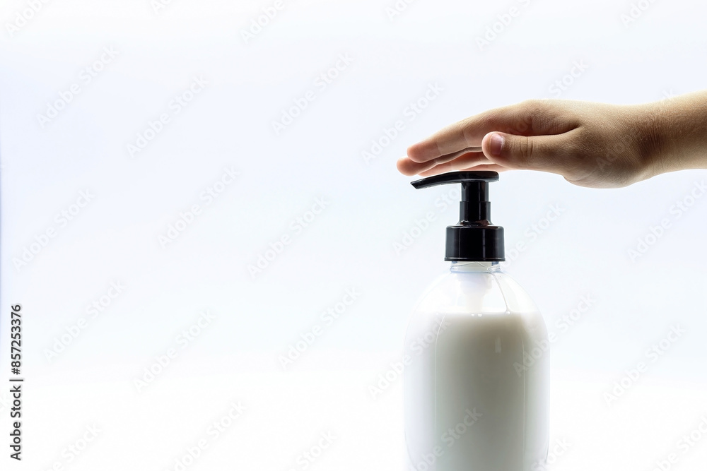 Hand hygiene concept. A child's hand on a soap bottle. Hand hygiene concept. A child's hand on a soap bottle.
