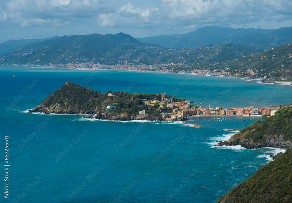 Panoramic aerial view of Bay of Silence and colorful, picturesque historical town Sestri Levante, Italy, popular resort in Liguria italian Mediterranean sea coast penisula. From Punta Manara path Panoramic aerial view of Bay of Silence and colorful, picturesque historical town Sestri Levante, Italy, popular resort in Liguria italian Mediterranean sea coast penisula. From Punta Manara path