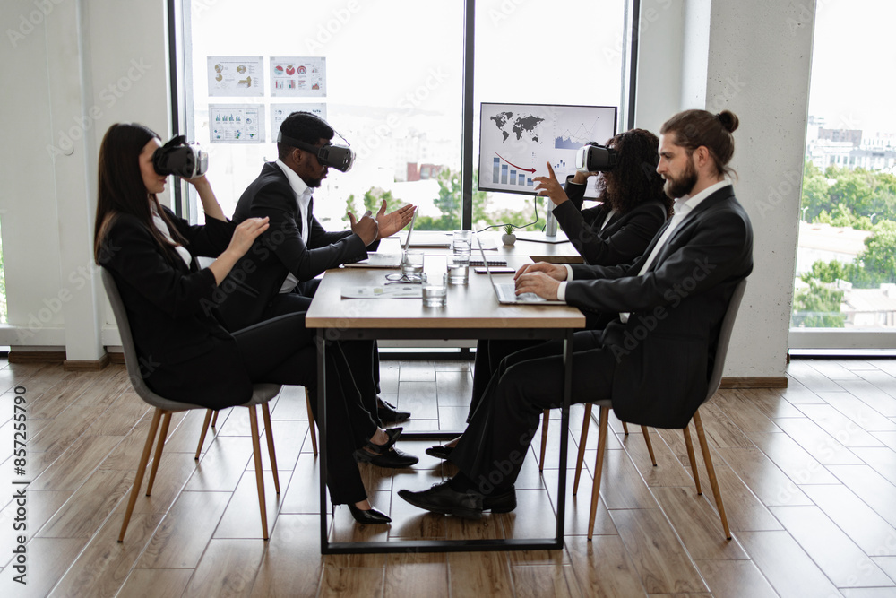 Business team using virtual reality headsets in modern office meeting. Colleagues demonstrating innovative technology during work presentation. Concept of teamwork, innovation, and technology. Business team using virtual reality headsets in modern office meeting. Colleagues demonstrating innovative technology during work presentation. Concept of teamwork, innovation, and technology.