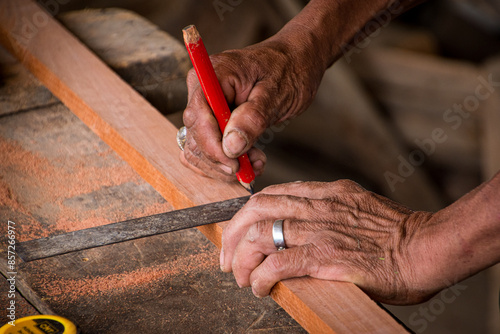 Elderly carpenter working in his home workshop