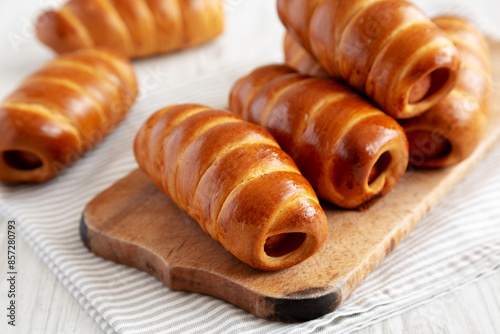 Photography Homemade Kolache Rolls on a rustic wooden board, side view.