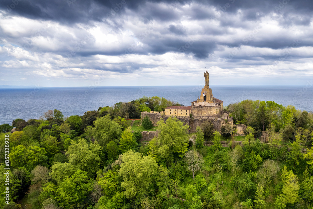 Aerial view of Mount Urgull and La Mota Castle looking over San Sebastian, Spain at La Concha Bay on a cloudy day Aerial view of Mount Urgull and La Mota Castle looking over San Sebastian, Spain at La Concha Bay on a cloudy day