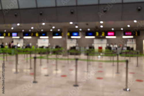 Airport waiting for passengers, Crowd Control barriers. Barrier tape on an airport. Blur abstract background. Blurred and defocused image of Airport Terminal.