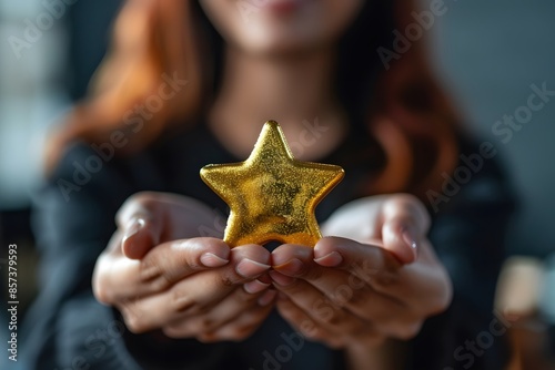 Person holding gold star smiling