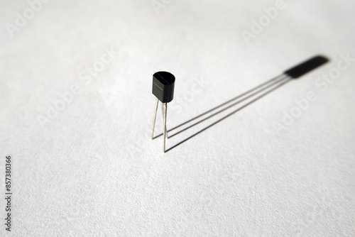 Single transistor and its shadow. Semiconductor electronic component.