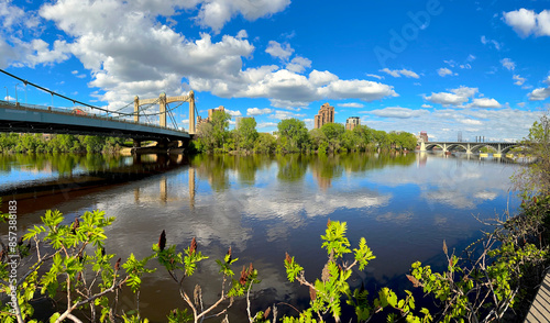Panoramic View of Mississipi River with Hennepin Avenue Bridge on the Left and the The Third Avenue Bridge on the Right, Minneapolis, Minnesota. City Scape, Trees Reflecting on the Water.  Landmarks. #857388183