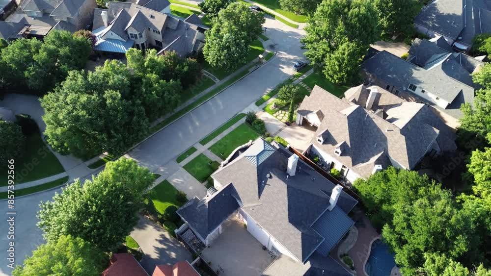 Flyover cul-de-sac dead end street in upscale suburbs Dallas residential neighborhood expensive two-story suburban mansion houses lush greenery trees, well-trimmed front yard landscape, Texas