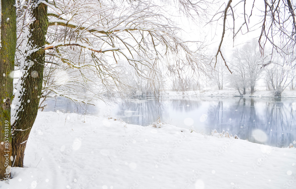 Heavy snowfall against the backdrop of a winter river and snow-covered trees. Heavy snowfall against the backdrop of a winter river and snow-covered trees.