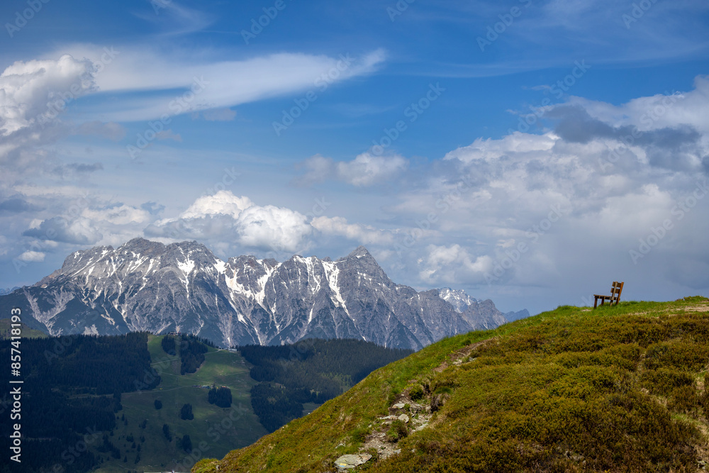 View on a mountain range in Austria, with a sitting bench View on a mountain range in Austria, with a sitting bench