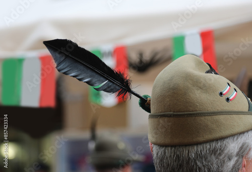 Typical hat of the Italian Alpine soldier during the national holiday and the Italian flags in the background