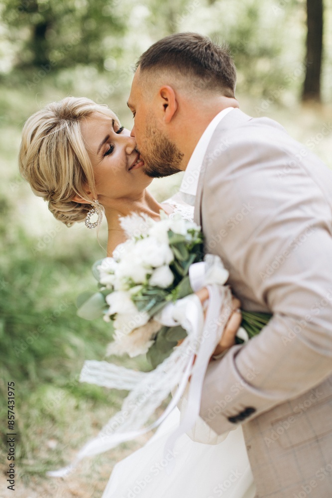 Couple, wedding and kissing with vail for love, compassion or affection together in nature. Married man kiss woman on lips, hugging in marriage, relationship or loving embrace for commitment outdoors Couple, wedding and kissing with vail for love, compassion or affection together in nature. Married man kiss woman on lips, hugging in marriage, relationship or loving embrace for commitment outdoors