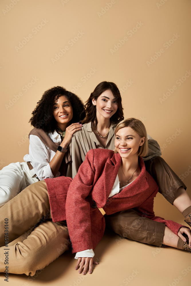 Beautiful multicultural women in stylish attire sit together, showcasing friendship and cultural diversity. Beautiful multicultural women in stylish attire sit together, showcasing friendship and cultural diversity.