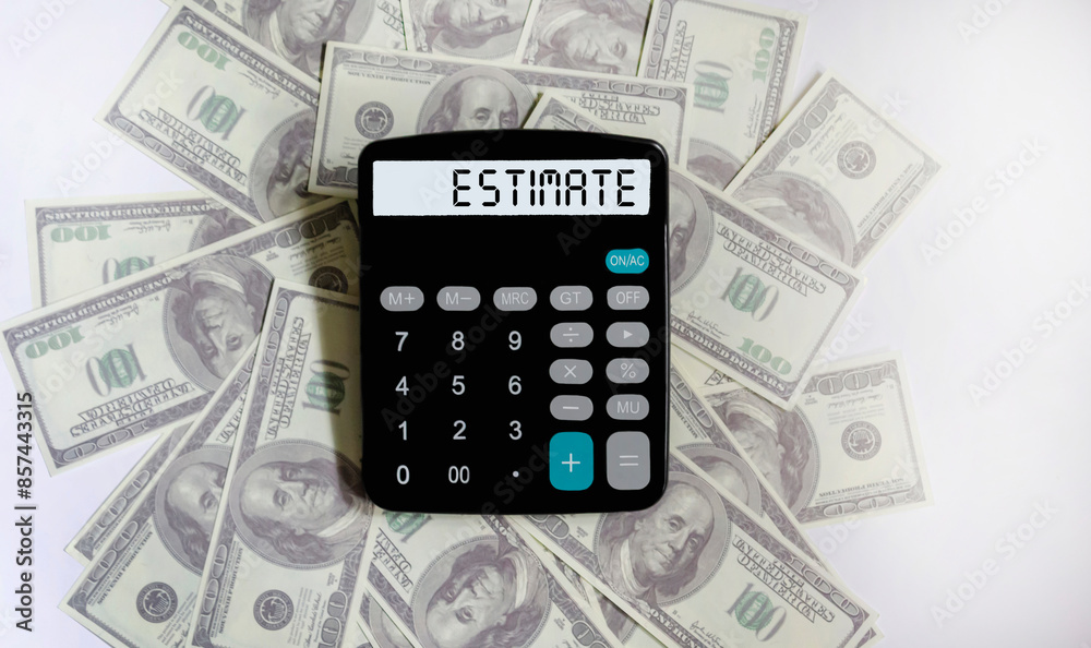 On the calculator is the word VALUATION on dollar bills. Cost calculation or estimation concept On the calculator is the word VALUATION on dollar bills. Cost calculation or estimation concept