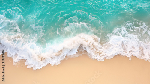 Aerial view of waves crashing onto a sandy beach with turquoise water.