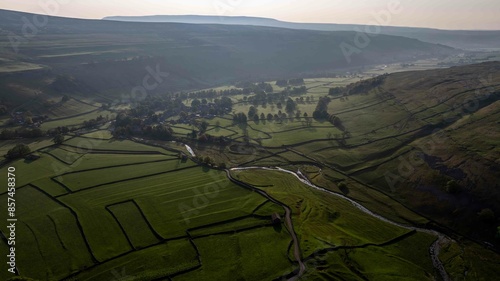 Mornings in Arncliffe are revealed in this image showing a drone view of the village with its defining cowside back winding between green fields and homes photo