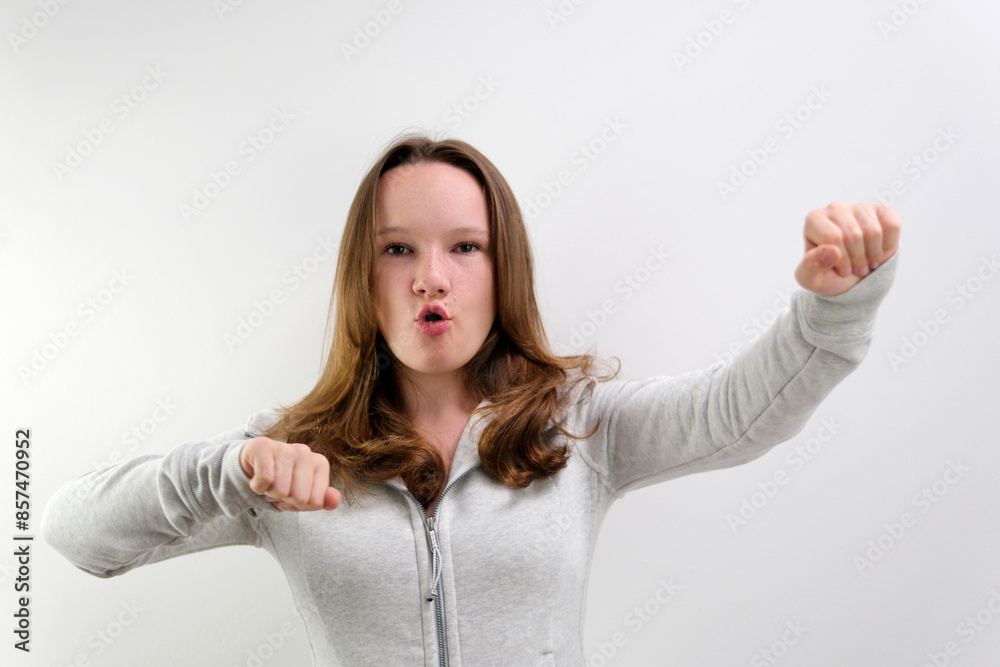 Emotions of people. Teen girl in green blouses dancing. Funny unusual woman hair having fun, hands up, grimaces, smiling, dancing in studio against green background. Music, dance concept. Emotions of people. Teen girl in green blouses dancing. Funny unusual woman hair having fun, hands up, grimaces, smiling, dancing in studio against green background. Music, dance concept.