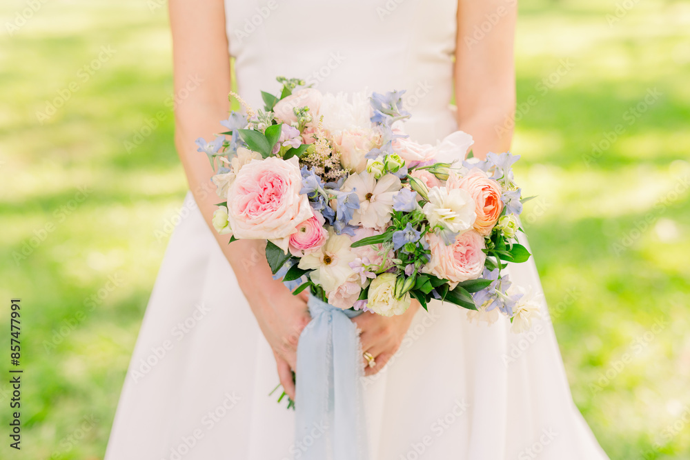 Bride is holding a summer bridal bouquet Bride is holding a summer bridal bouquet