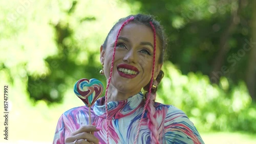 Beautiful girl with pink dreadlocks and a lollipop