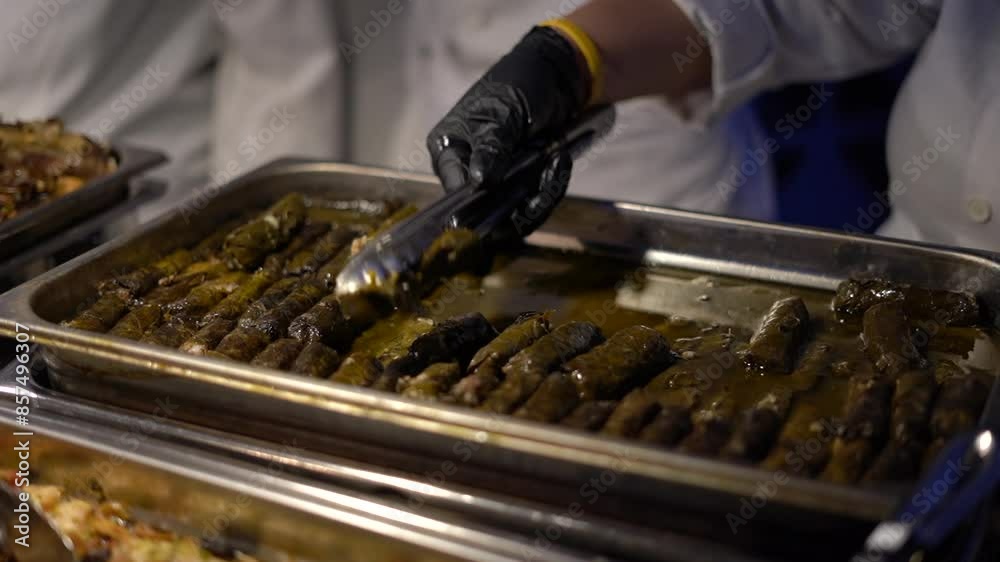 person serving food at a restaurant buffet person serving food at a restaurant buffet