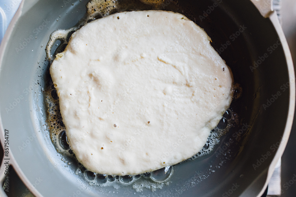 cooking pancakes in a frying pan cooking pancakes in a frying pan