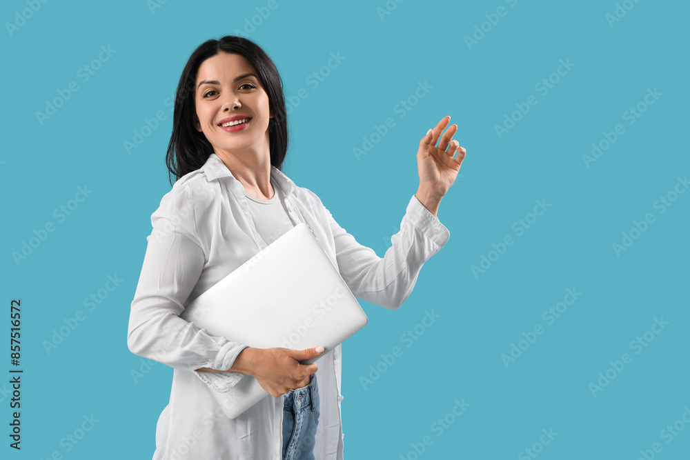 Female programmer with laptop on blue background Female programmer with laptop on blue background