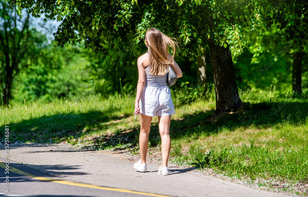 Girl walks in the city summer Park
Girl walks in the city summer Park