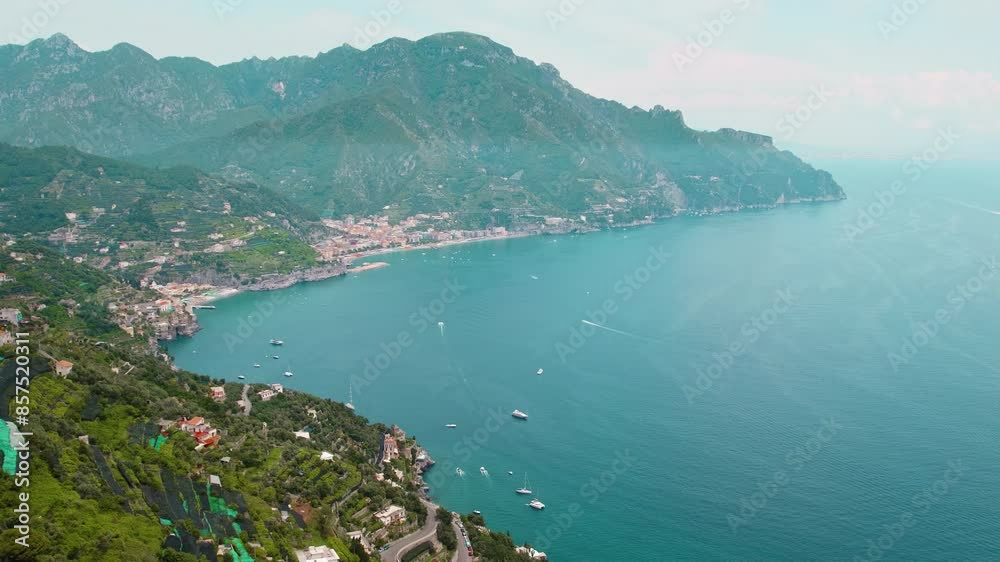 Beautiful summer day on the Amalfi Coast, Italy, with lush greenery and clear blue waters seen from above. Beautiful summer day on the Amalfi Coast, Italy, with lush greenery and clear blue waters seen from above.