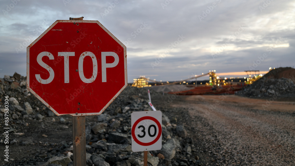 Traffic STOP and 30 km/h speed limit signs next to mine haul road for ...