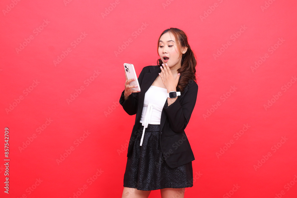 gesture of surprised young asian career girl wearing black formal suit hand operating smartphone cell phone, for technology, business, advertising, financial content gesture of surprised young asian career girl wearing black formal suit hand operating smartphone cell phone, for technology, business, advertising, financial content