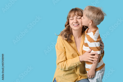 Little son kissing her happ...