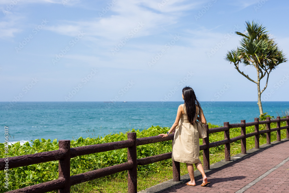 Travel woman look at the sea at summer time