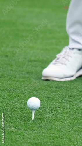 A professional golfer started a game of golf. A golfer taking a shot on the golf course.