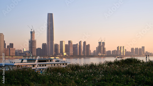 city skyline of wuhan on the bank of yangtze river at sunset © Juntao