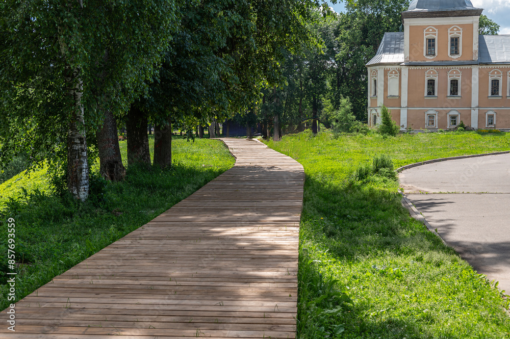 Wooden walking path among trees in the park. Wooden walking path among trees in the park.