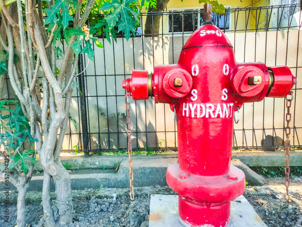 A red hydrant is installed in a residential area A red hydrant is installed in a residential area