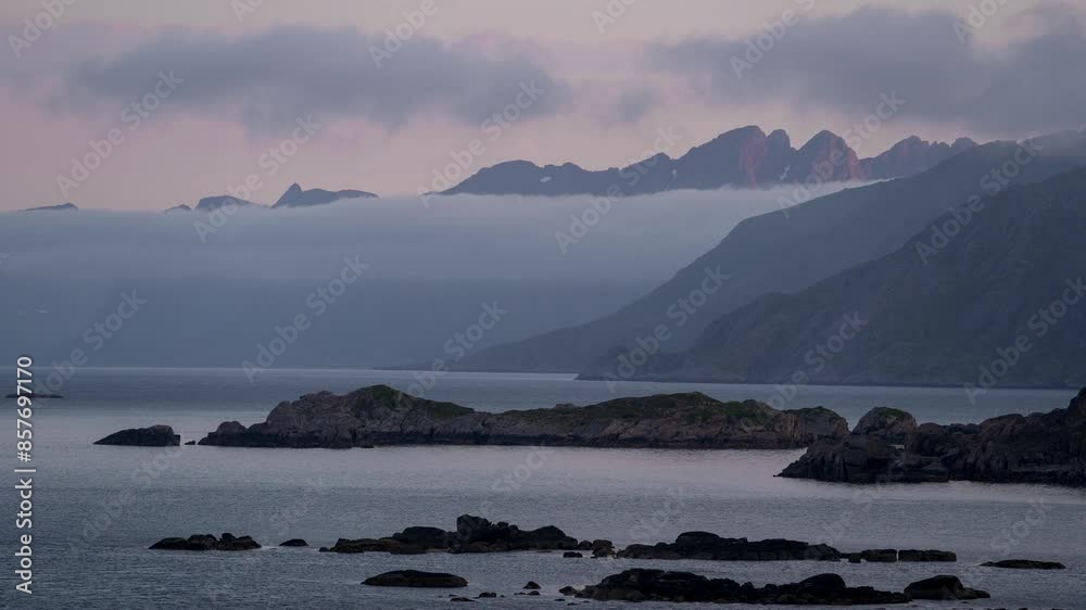 Timelapse of a restless fjord and fast-moving clouds over a dramatic landscape in Lofoten Islands, Norway. Timelapse of a restless fjord and fast-moving clouds over a dramatic landscape in Lofoten Islands, Norway.