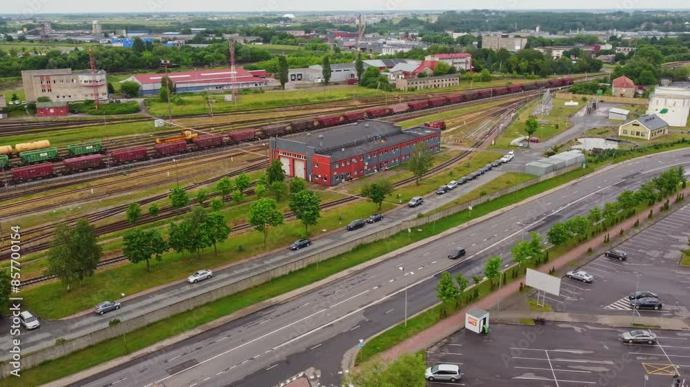 Freight train leaving depot of Klaipeda city, aerial view Freight train leaving depot of Klaipeda city, aerial view